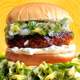 Plant-based burger with scallion sauce, on top of a bed of scallion sauce